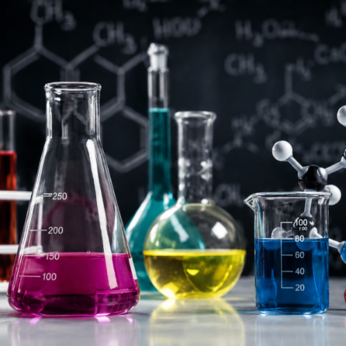 Laboratory flasks and a beaker containing colorful chemical solutions are displayed in the foreground, with atomic models and molecular structure diagrams in the background representing the study of chemistry.